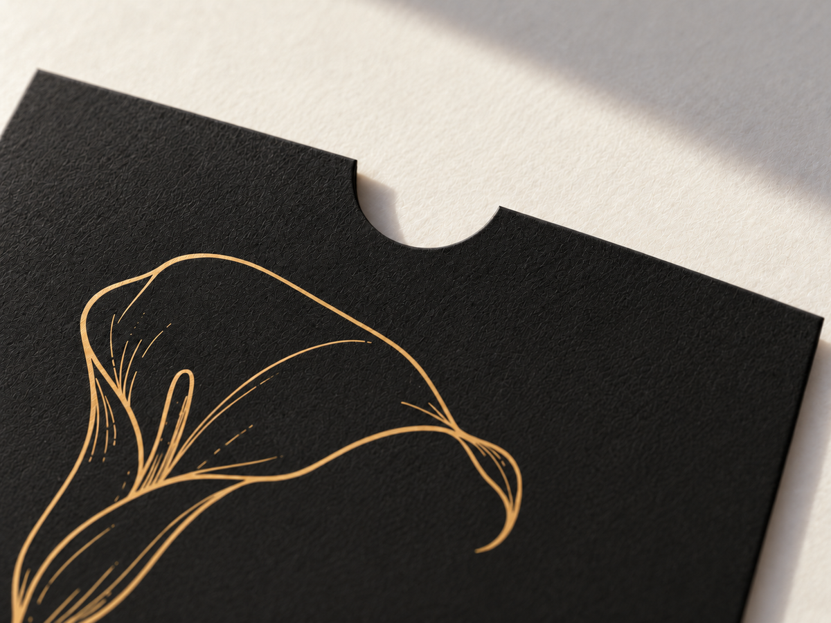 Close-up of the black sleeve texture, rounded top notch, and gold calla lily artwork.