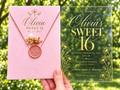 Clear Sweet 16 invitation with gold daisy design, pink envelope, pink wax seal and dried flowers.