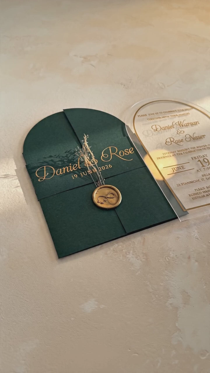 Video showing the green cover's wax seal and dried flowers, then lifting and tilting the clear arched acrylic invitation to show its transparency.